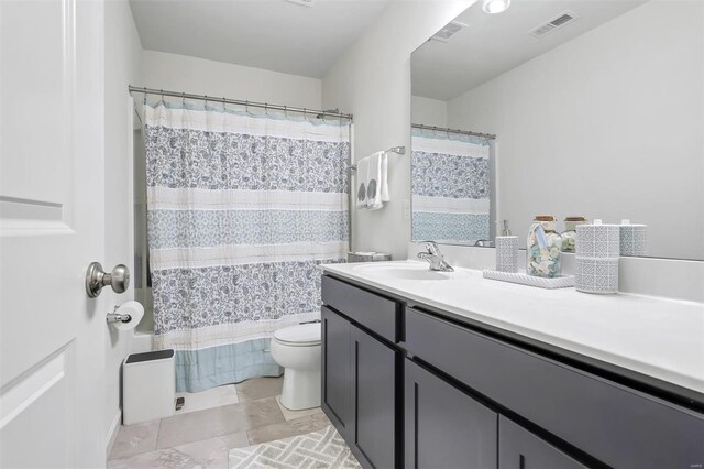 bathroom with vanity, toilet, and visible vents