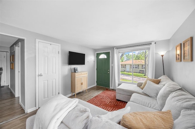 living room with baseboards and wood finished floors