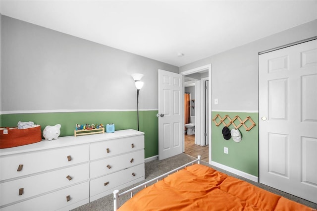 bedroom featuring baseboards and carpet