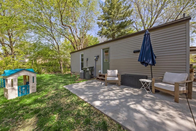 rear view of property featuring a patio and a yard