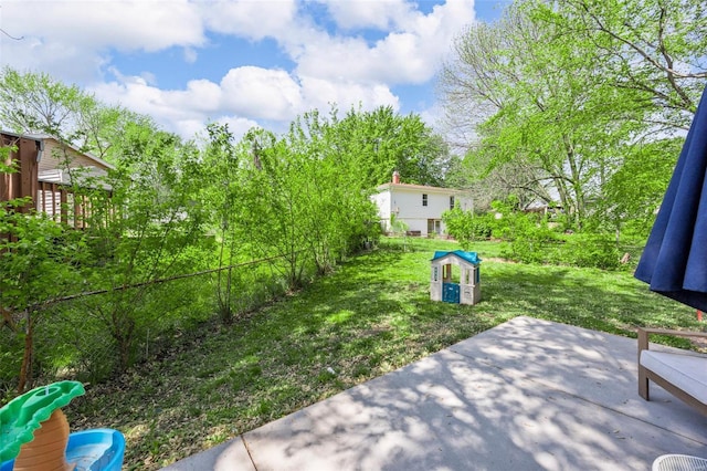 view of yard featuring fence and a patio area