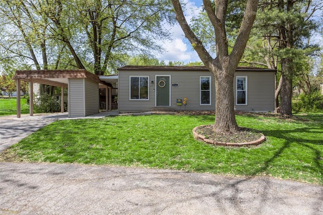 ranch-style house with a front lawn, driveway, and an attached carport
