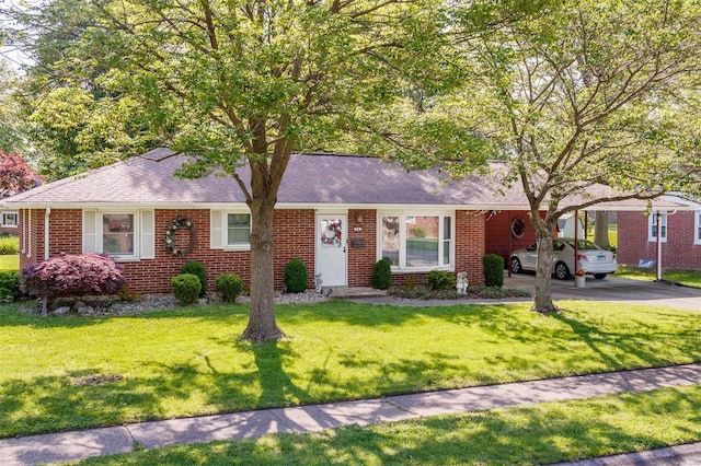 single story home with roof with shingles, driveway, a front lawn, and brick siding
