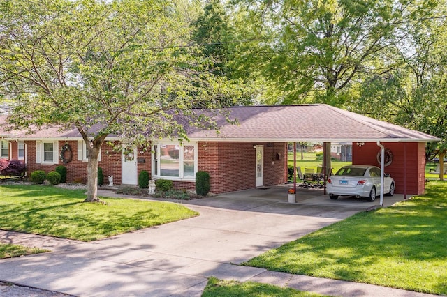 single story home featuring brick siding, driveway, a front yard, and an attached carport