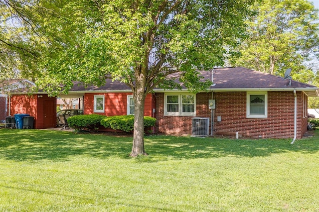 view of front of house with brick siding, central AC, a shingled roof, and a front lawn