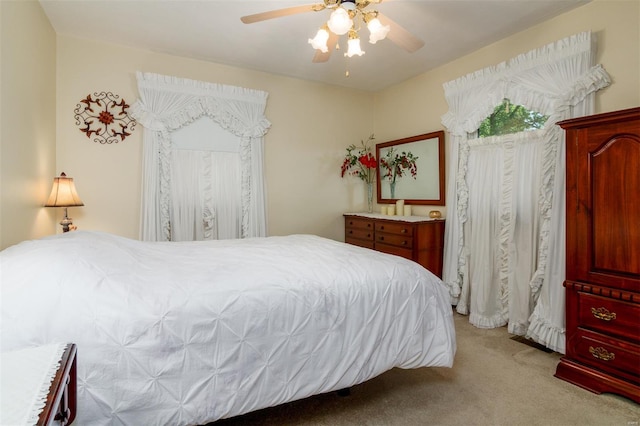 bedroom with a ceiling fan and light carpet