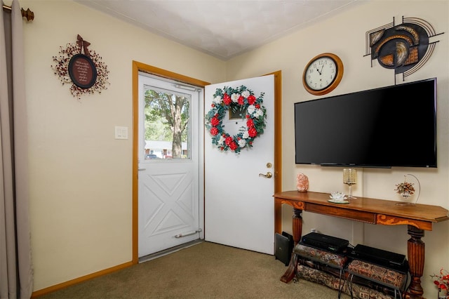 view of carpeted foyer entrance
