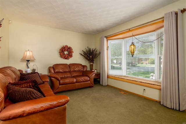 living room featuring baseboards, carpet flooring, and visible vents