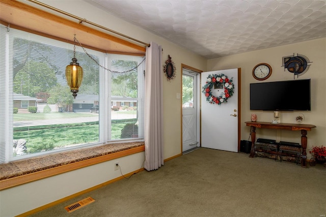 living area with light colored carpet and visible vents