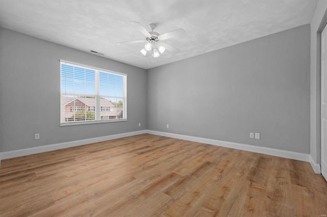 unfurnished room featuring ceiling fan, visible vents, baseboards, and light wood-style floors