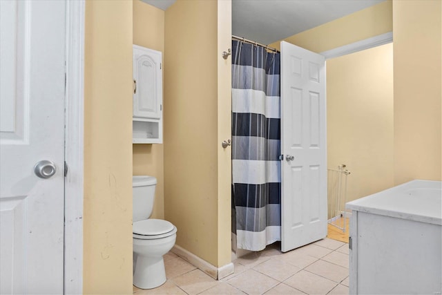 bathroom with a shower with shower curtain, tile patterned floors, and toilet
