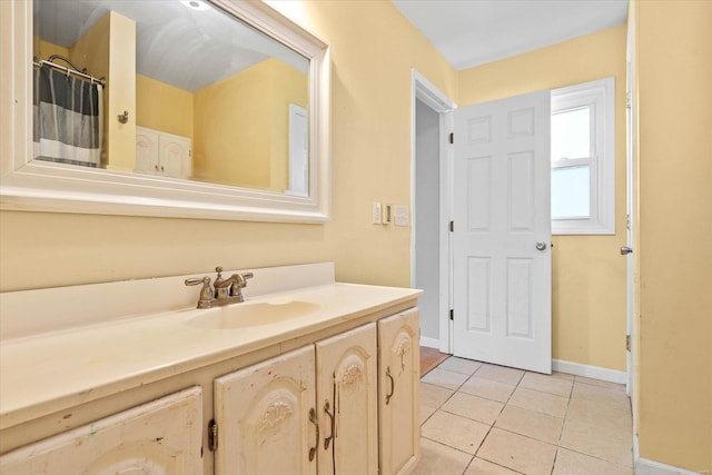 full bathroom featuring tile patterned floors, baseboards, and vanity