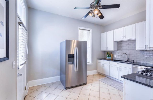 kitchen with white cabinetry, baseboards, a sink, and stainless steel fridge with ice dispenser