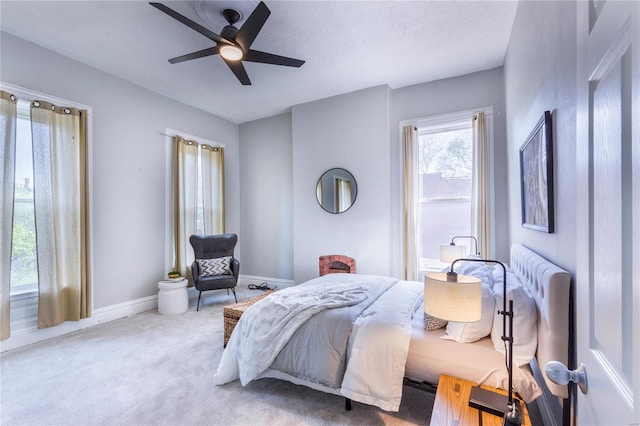carpeted bedroom featuring a ceiling fan and baseboards