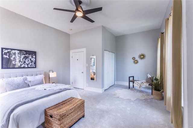 bedroom with baseboards, ceiling fan, and light colored carpet