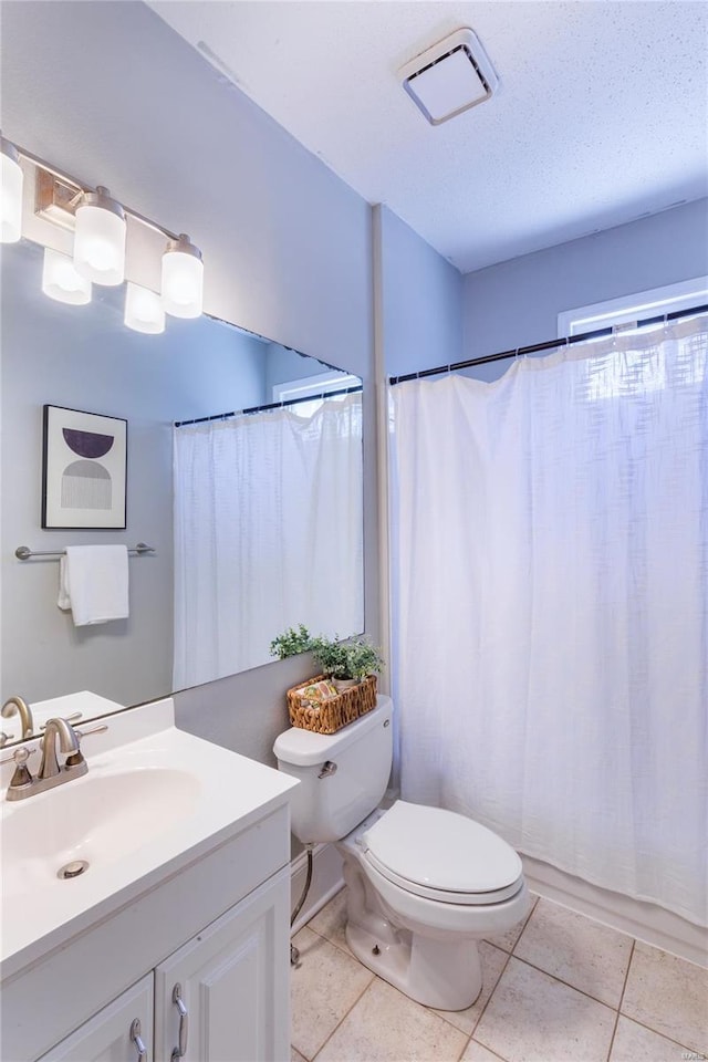 full bath featuring vanity, visible vents, toilet, a shower with shower curtain, and tile patterned floors