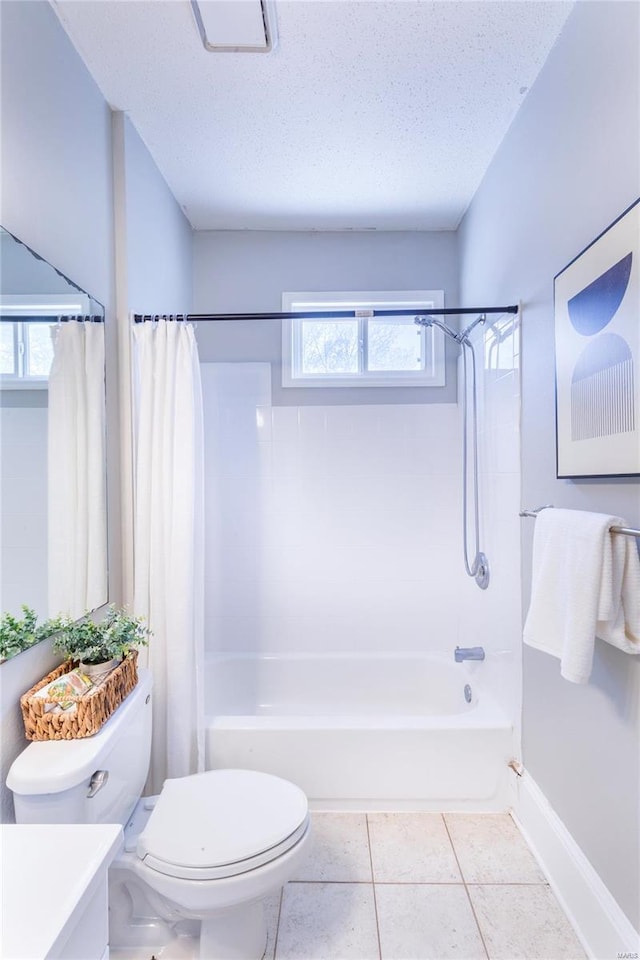 full bath featuring a textured ceiling, shower / bath combo, vanity, tile patterned floors, and toilet