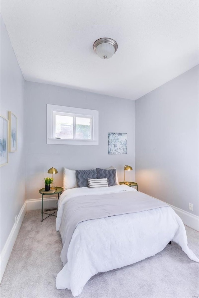 bedroom with baseboards and carpet flooring