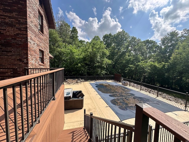 wooden terrace featuring a patio, a community pool, and fence