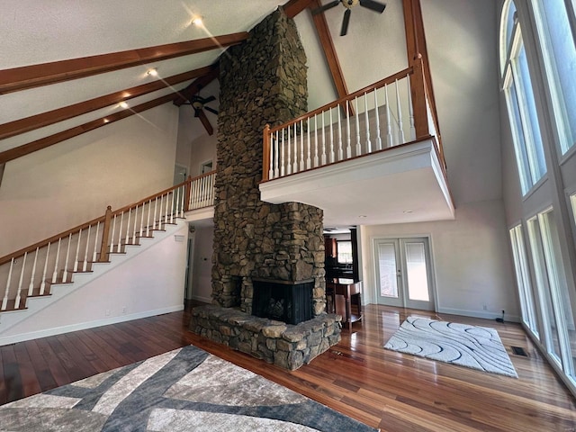 living room with high vaulted ceiling, a ceiling fan, and hardwood / wood-style flooring