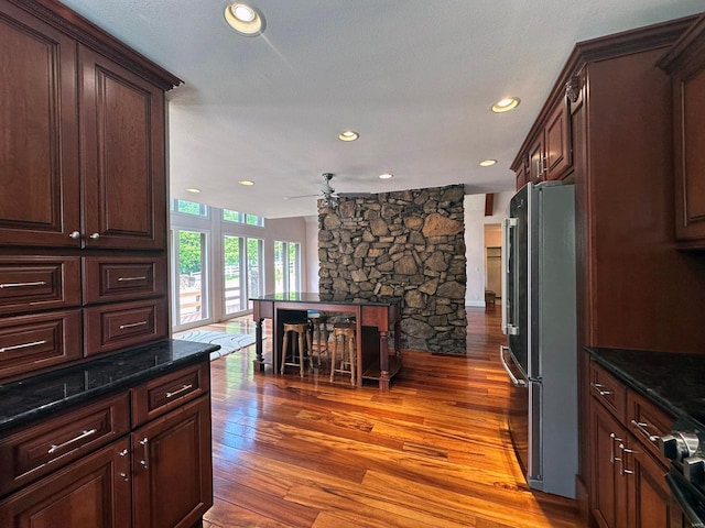 kitchen featuring dark brown cabinets, ceiling fan, light wood-style floors, freestanding refrigerator, and recessed lighting