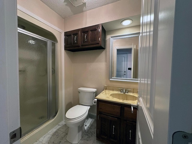 bathroom with a textured ceiling, a shower stall, vanity, toilet, and marble finish floor