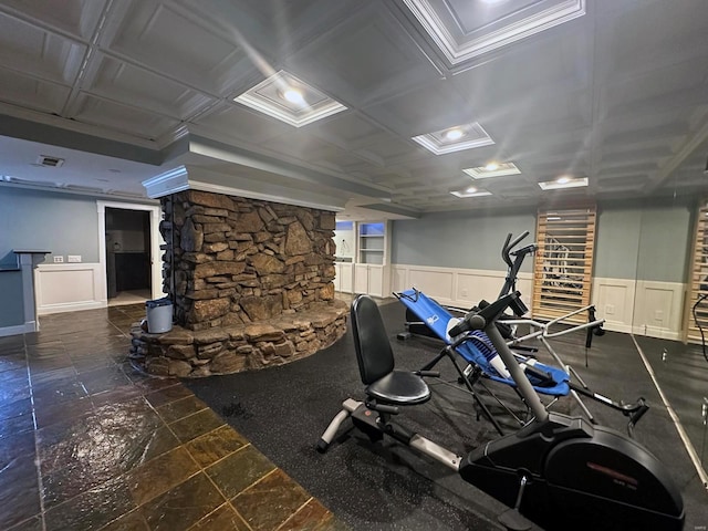 workout room with a wainscoted wall and visible vents
