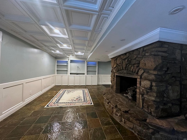 interior space with a decorative wall, stone finish floor, and a wainscoted wall