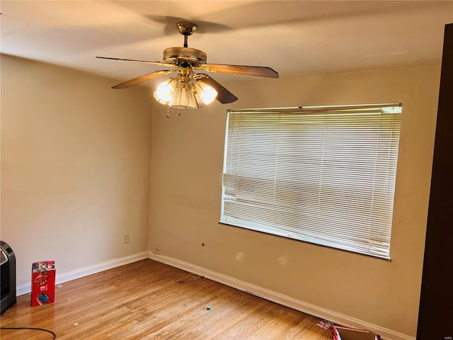 unfurnished room featuring baseboards, ceiling fan, and light wood-style flooring