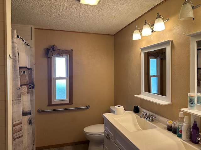 bathroom with a textured wall, vanity, toilet, a textured ceiling, and a shower with shower curtain