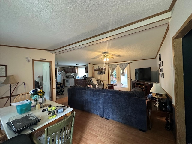 living area with crown molding, ceiling fan, a textured ceiling, and wood finished floors