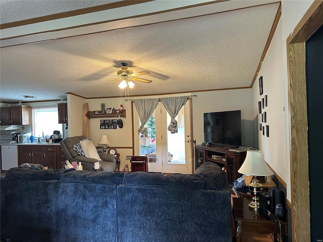 living room featuring crown molding, a ceiling fan, and a textured ceiling