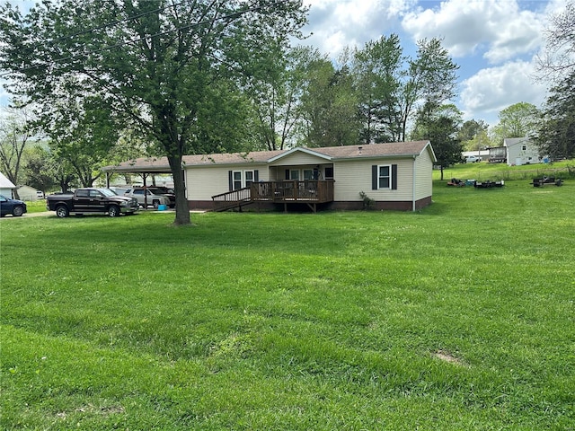 view of front facade with a wooden deck, a carport, and a front lawn