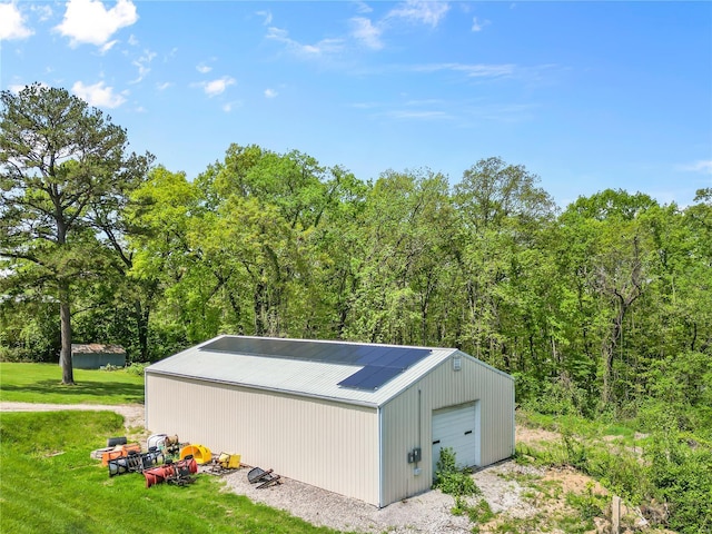 view of outdoor structure featuring an outbuilding and a forest view