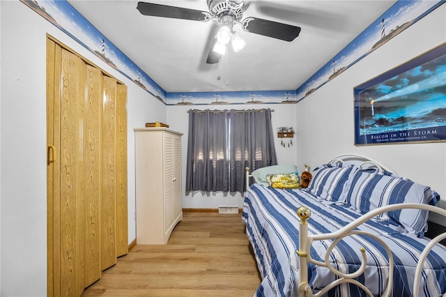 bedroom with light wood-type flooring, ceiling fan, and visible vents