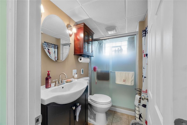 full bathroom featuring vanity, visible vents, toilet, a drop ceiling, and a shower stall
