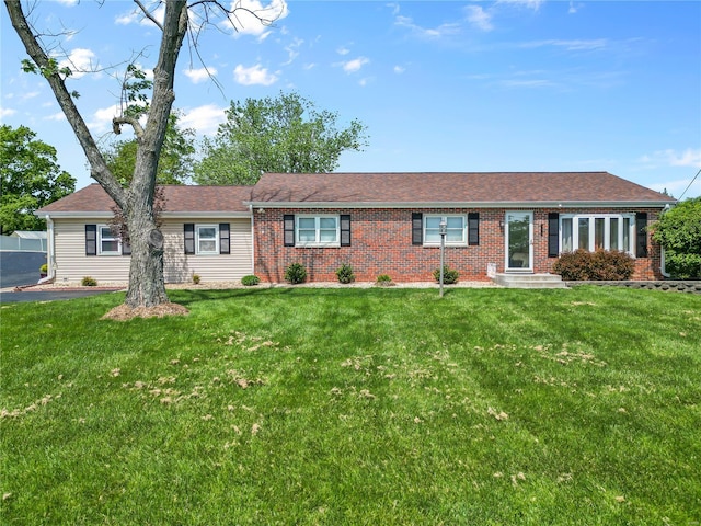 single story home featuring a front lawn and brick siding