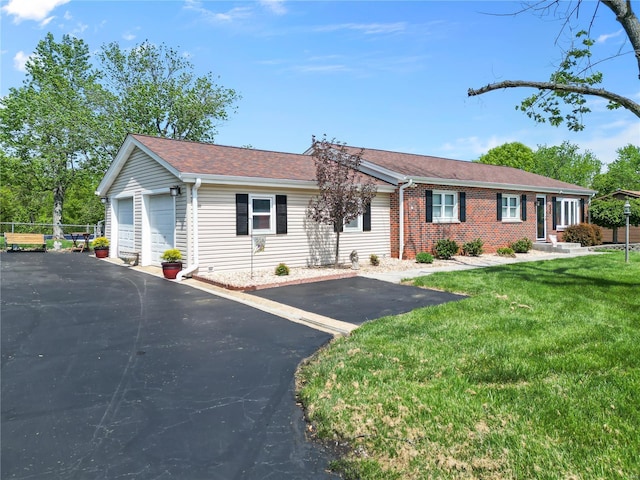 ranch-style home with brick siding, a garage, roof with shingles, and a front lawn