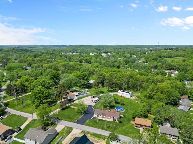 birds eye view of property featuring a view of trees