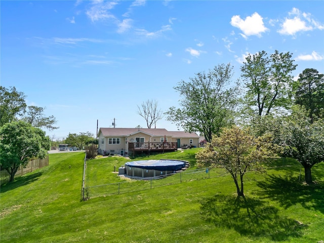 view of yard featuring fence and a wooden deck