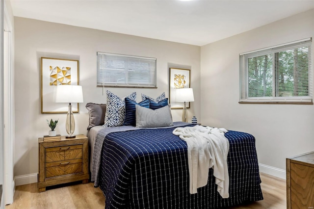 bedroom featuring baseboards and light wood-style flooring