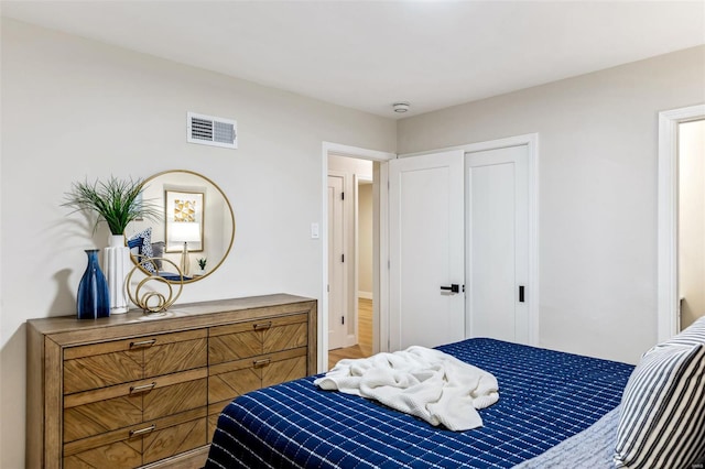 bedroom featuring a closet and visible vents