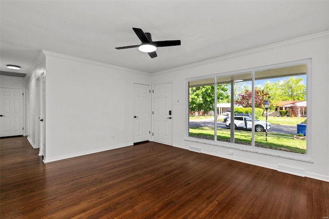 unfurnished room featuring visible vents, a wealth of natural light, and dark wood finished floors