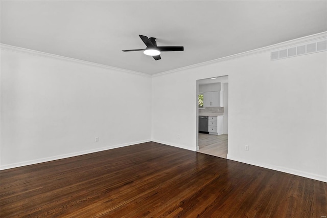 empty room featuring a ceiling fan, visible vents, crown molding, wood finished floors, and baseboards