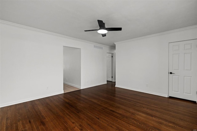 empty room with ceiling fan, visible vents, crown molding, wood finished floors, and baseboards