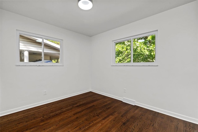 unfurnished room with a healthy amount of sunlight, baseboards, and visible vents