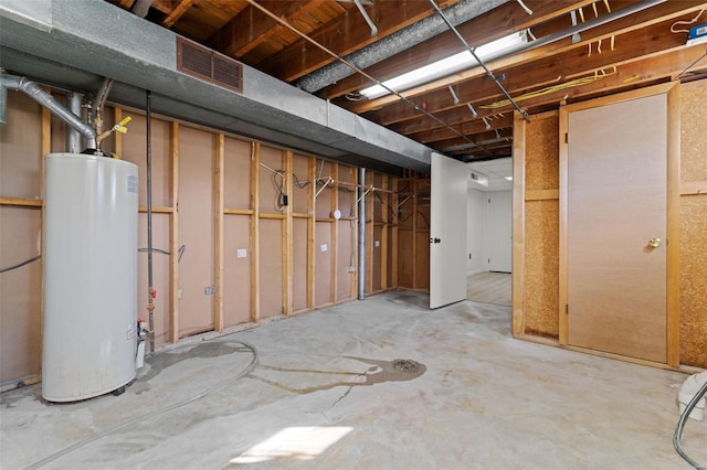 unfinished below grade area with visible vents and gas water heater