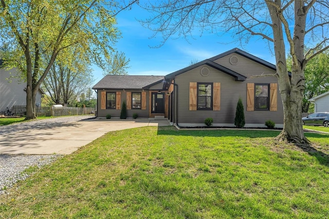 ranch-style house with fence, driveway, and a front yard