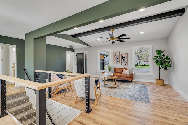 living area with light wood-style floors, baseboards, lofted ceiling with beams, and recessed lighting