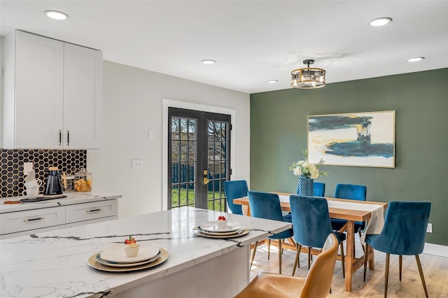 dining space featuring recessed lighting, baseboards, french doors, and light wood-type flooring